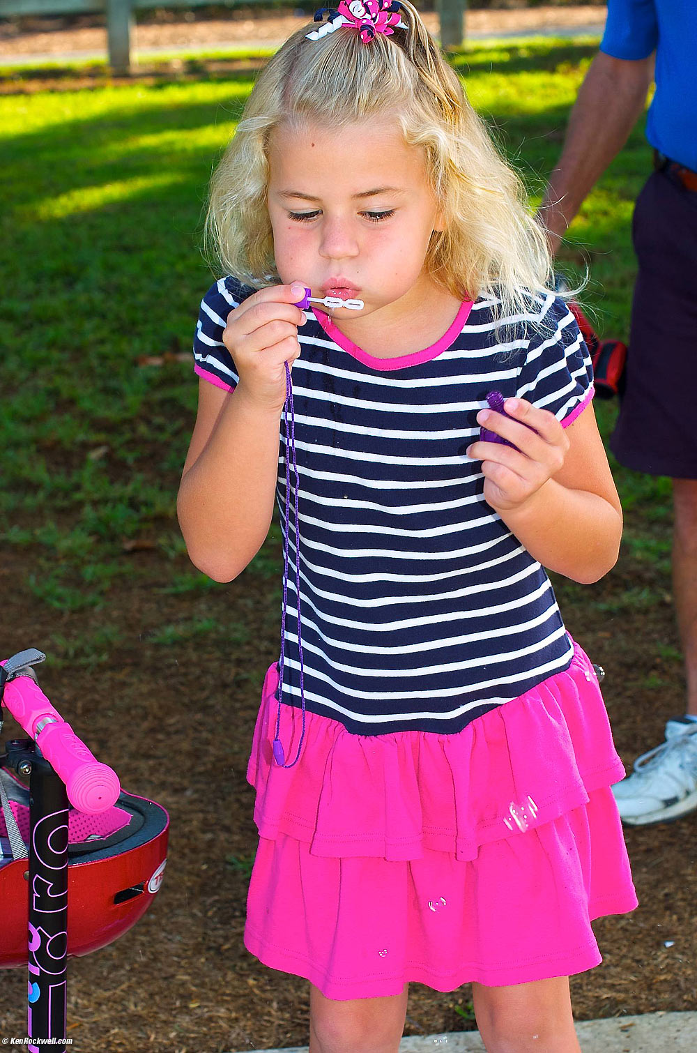 Katie blowing bubbles at Noni's park. 