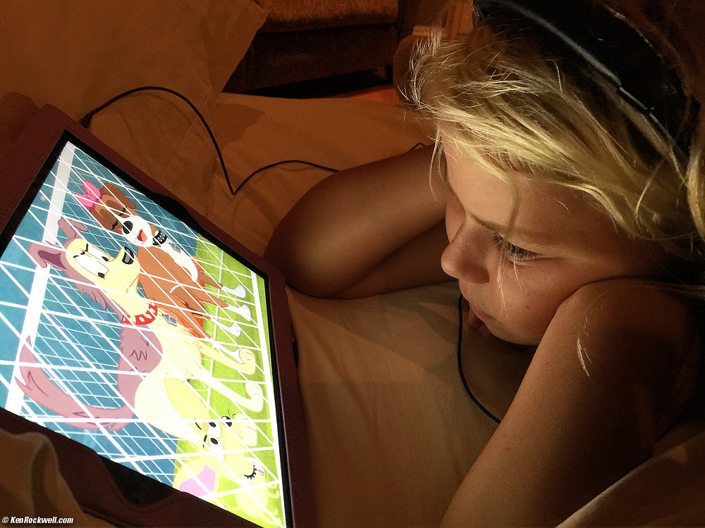 Katie watches cartoons on an iPad.