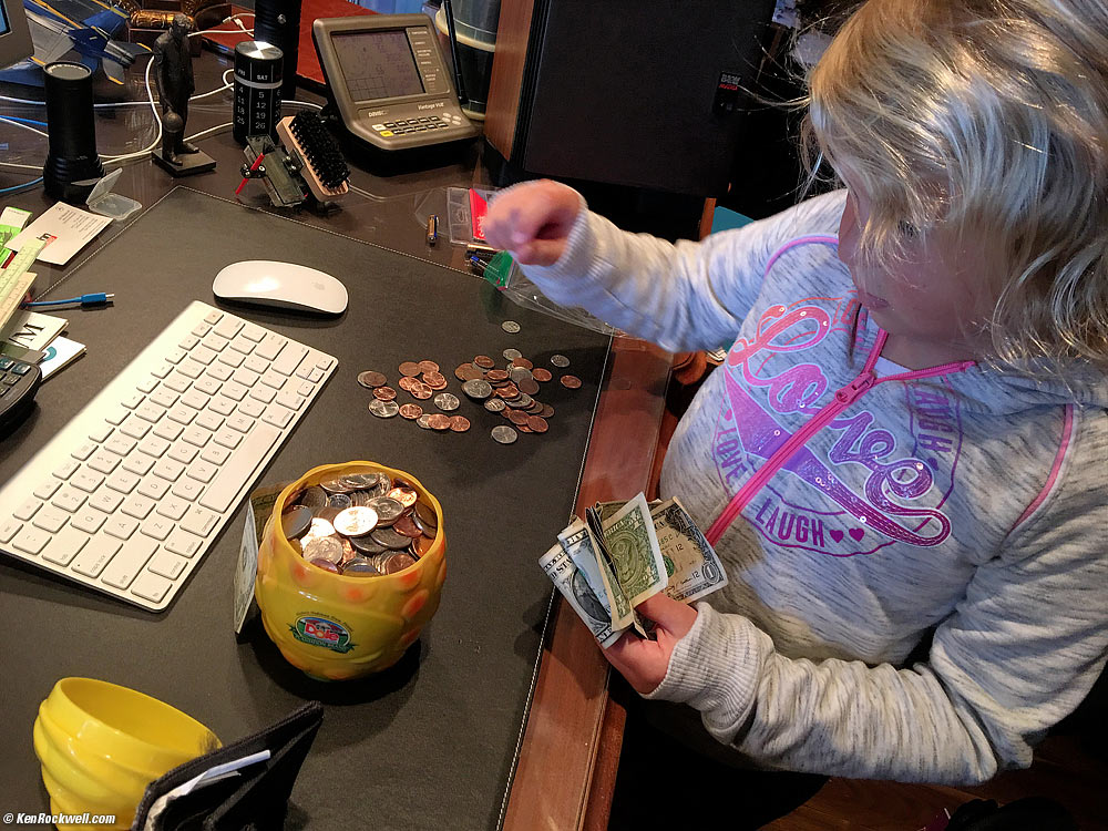 Katie changes money at Dada's Bank.