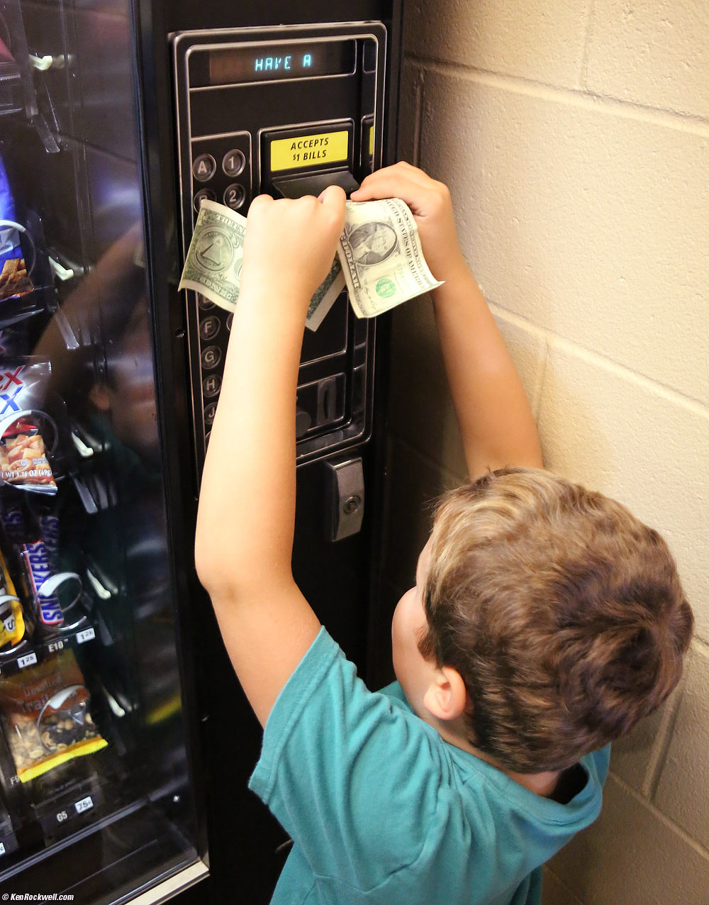 Ryan scores two dollars from Dada and wants some Chex Mix from the snack machine