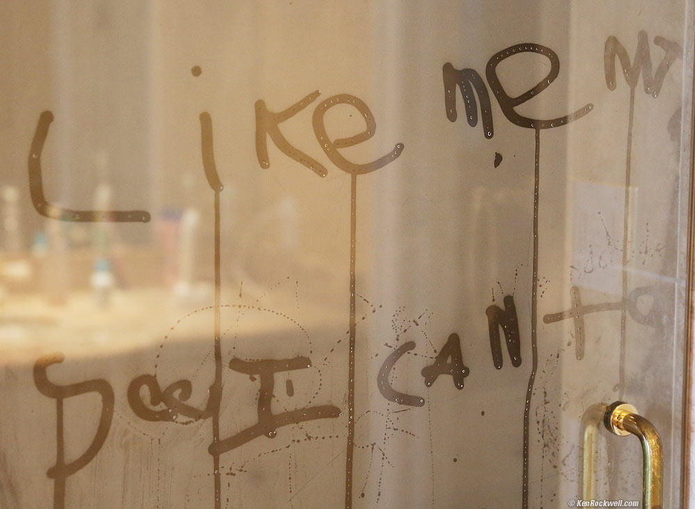 Ryan writes on the shower door. 