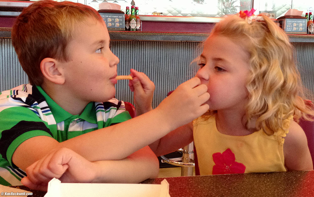 Ryan and Katie feeding each other french Fries at Fatburger