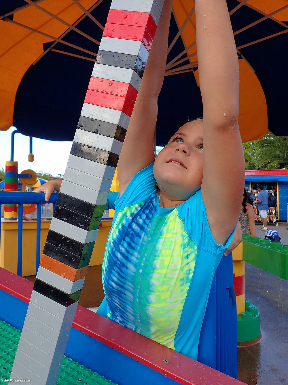 Katie makes a tall tower at the Legoland water table.