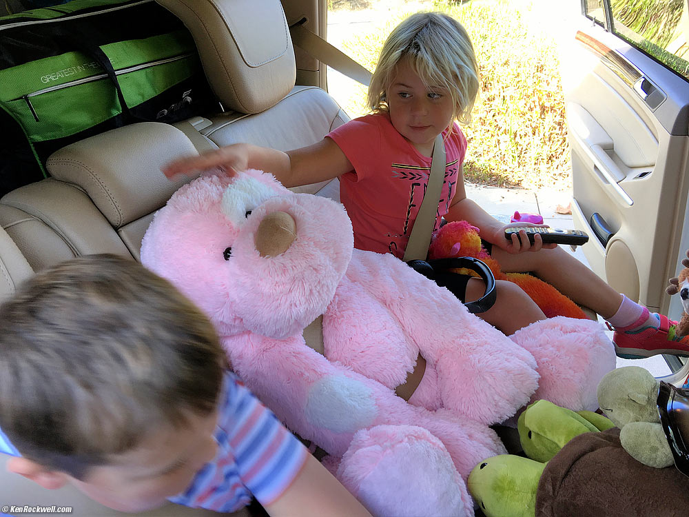 Katie straps in her big pink stuffed animal into Stomper.