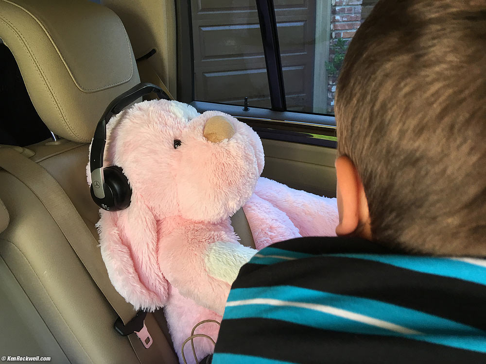 Ryan put Katie's big pink stuffed animal in her seat, and put her headphones on it.