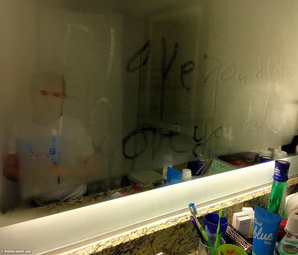 Ryan writes "I Love You Dad" in the fog on the bathroom mirror