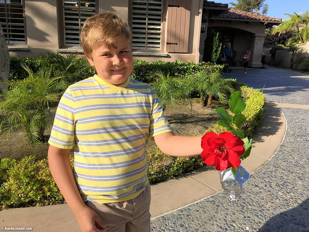 Ryan and a flower he picked for his 3rd grade teacher.