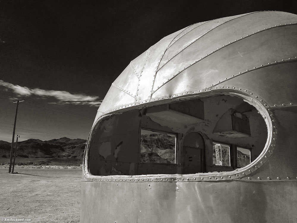 Motel Sign Seen Through an Airstream trailer