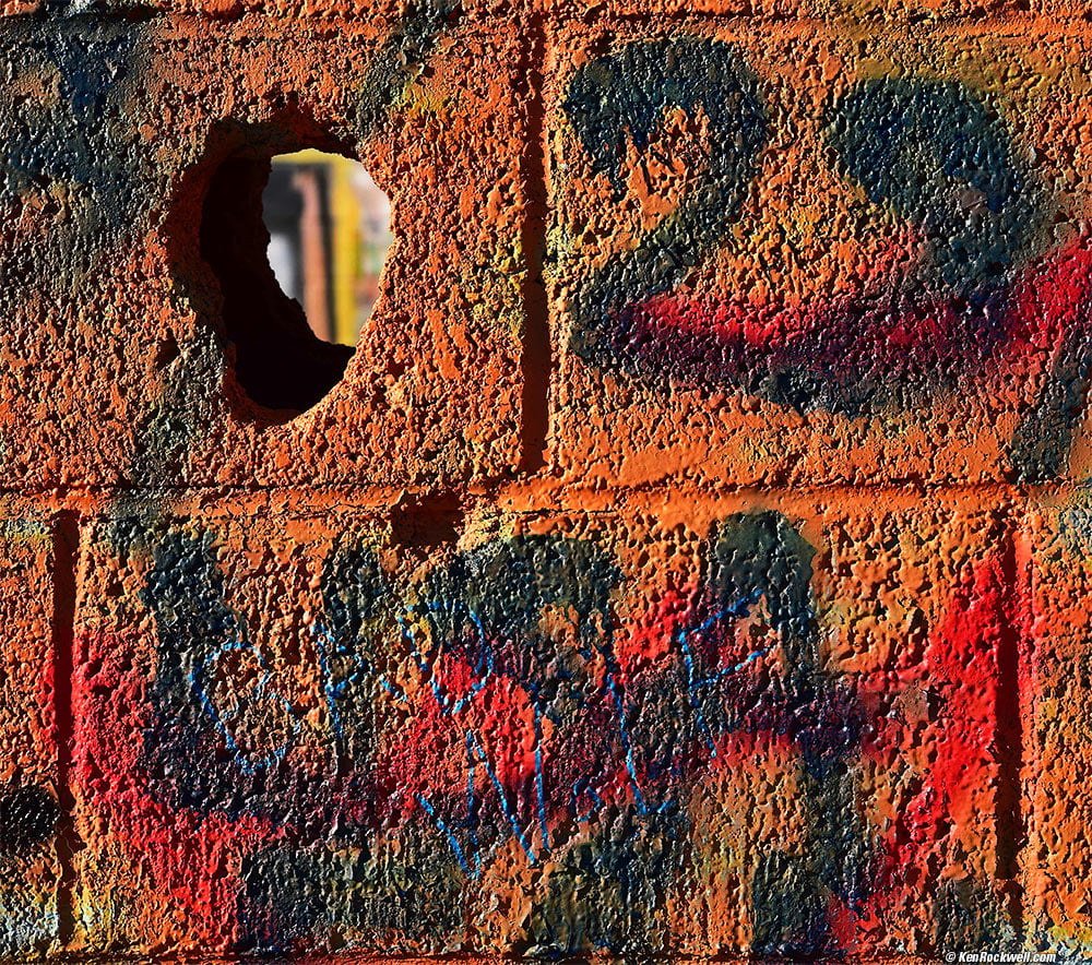 Colorful Graffiti on Cinder-Block Wall with Hole